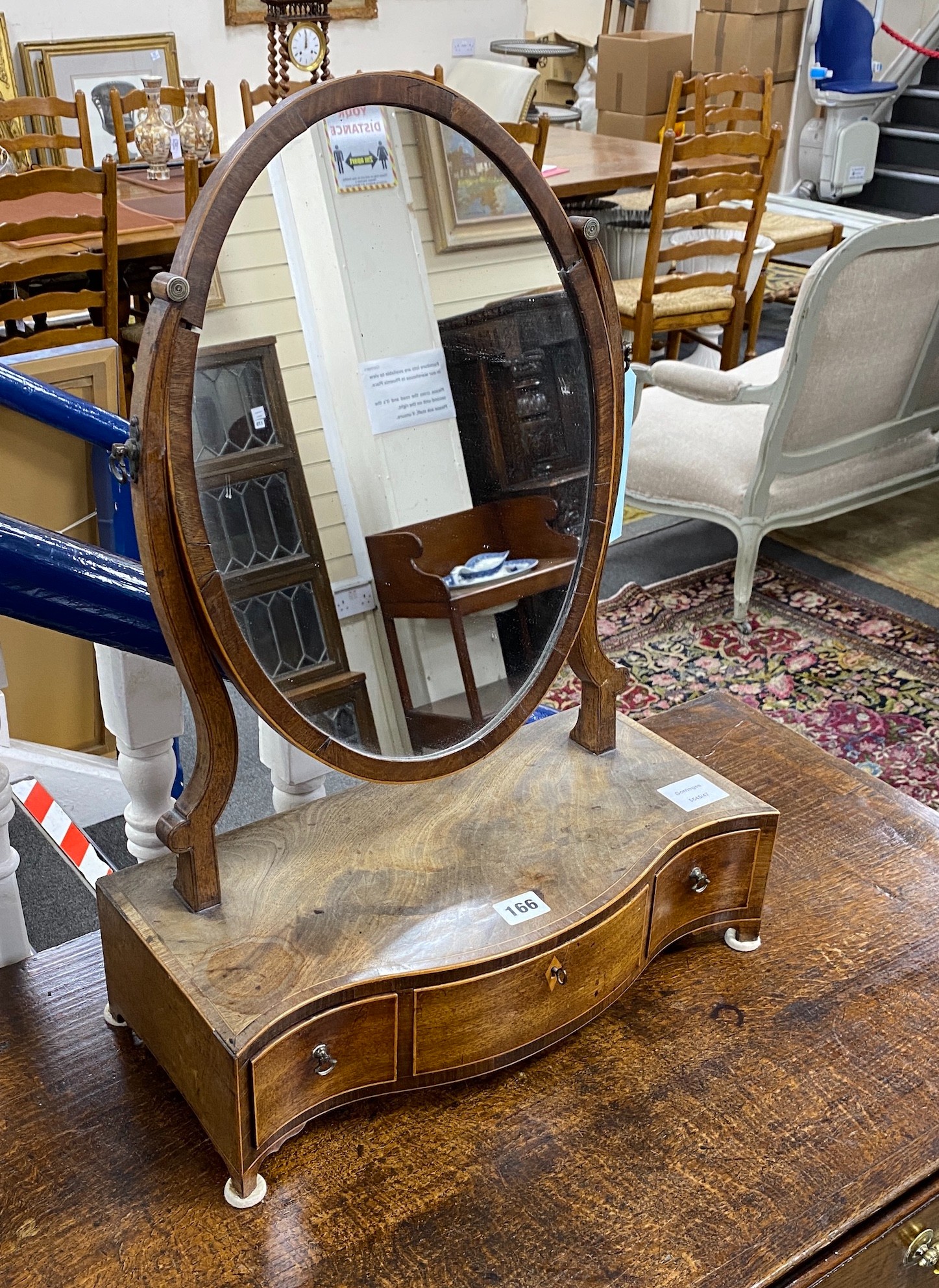 A George III tulipwood banded mahogany serpentine fronted toilet mirror, width 43cm, depth 21cm, height 58cm